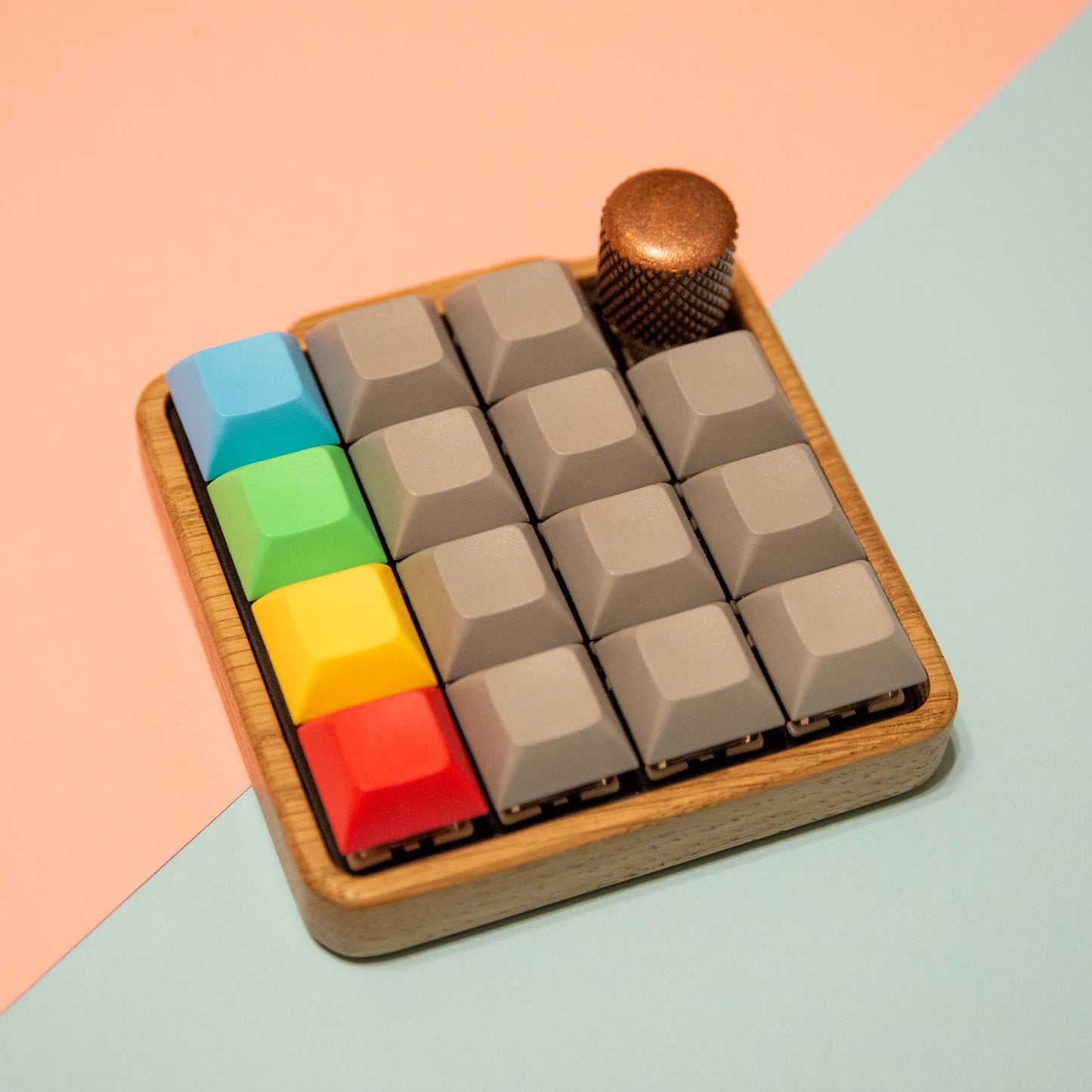 Colorful keyboard keycaps on a wooden base with a gradient background