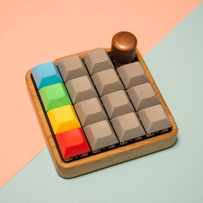 Colorful keyboard keycaps on a wooden base with a gradient background